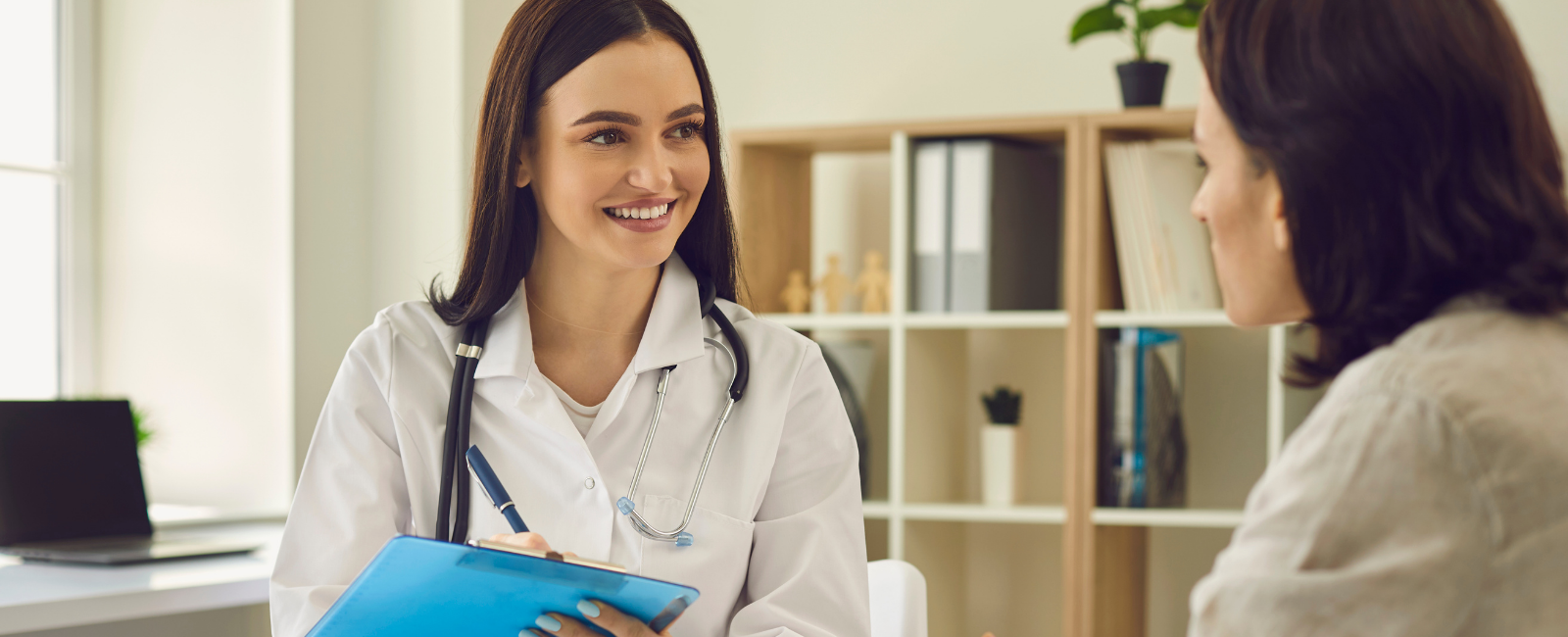 Two people talking in an medical office.